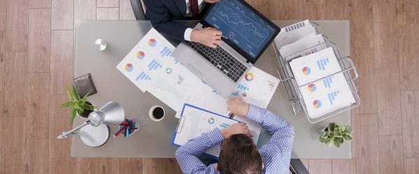 top-view-of-businessmen-analyzing-management-statistics-while-working-at-company-investments.jpg
